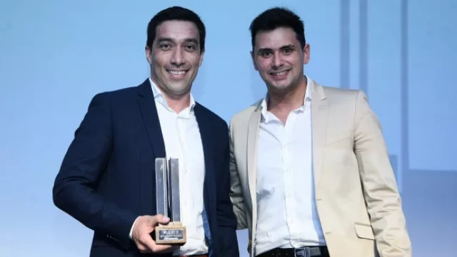 Rolando Arias recibiendo el premio que entregó Nico Leoni de mejor agencia M.
