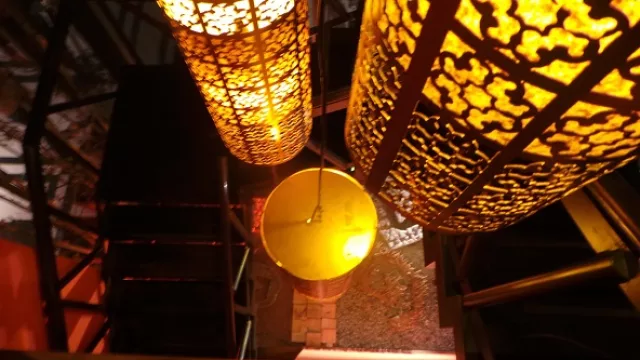 Las lámparas conectan el patio Zen principal con el primer piso.