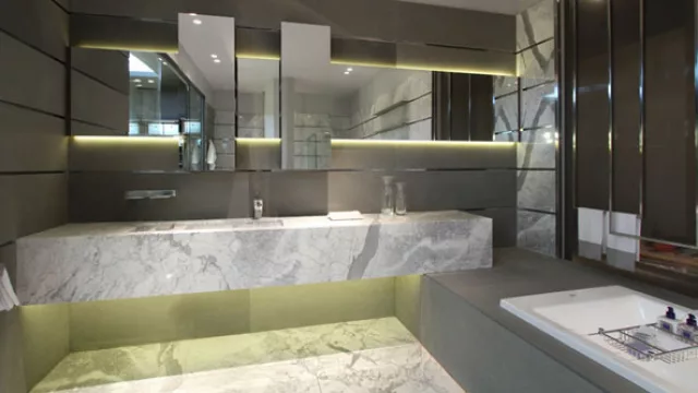 La mesada fue pensada como un  bloque puro y tectónico que encuentra apoyo sobre la tarima de la bañera.